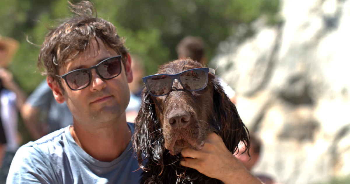 Man and dog wearing sunglasses
