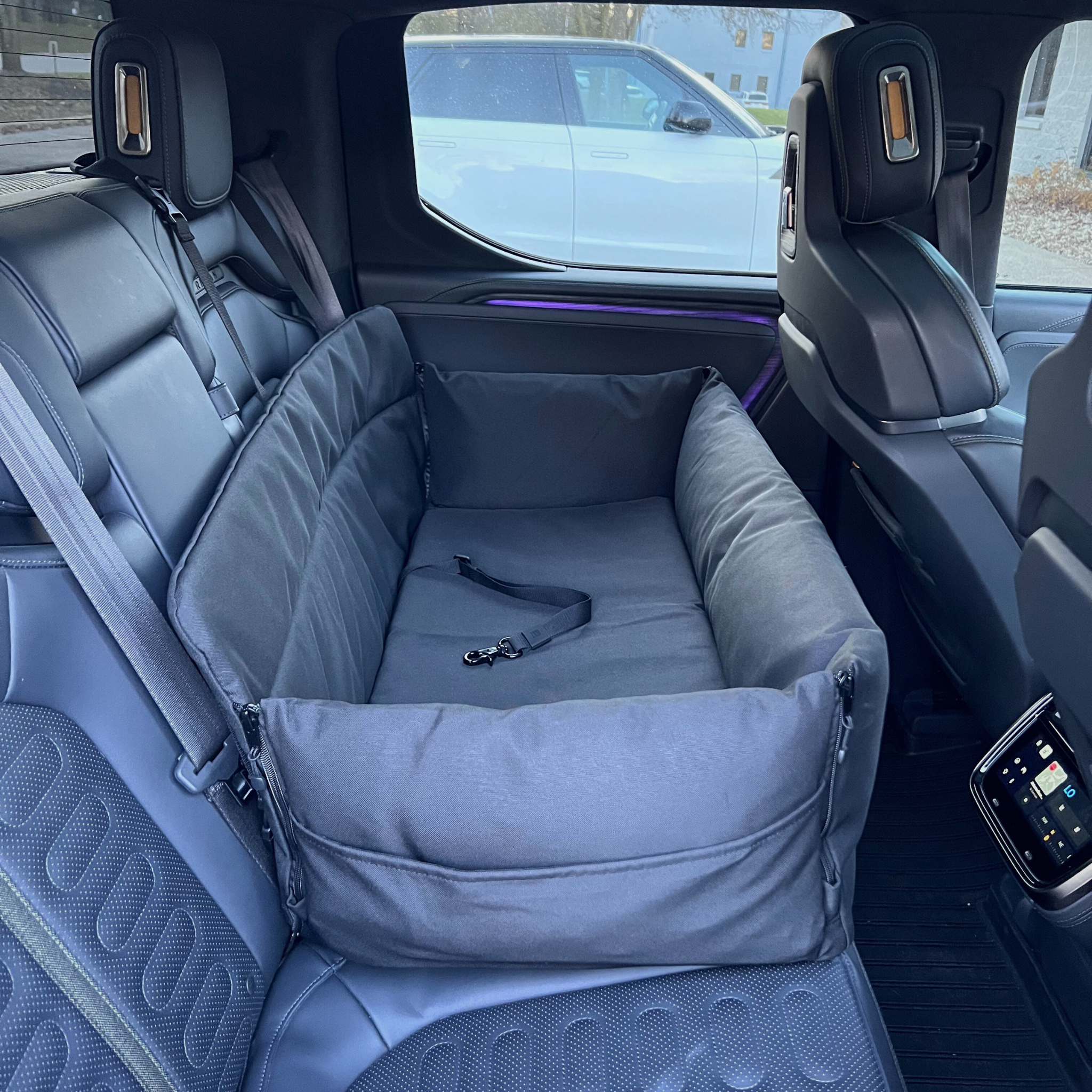 Venture Travel Car Dog Bed in the back seat of a Rivian Electric Pickup truck